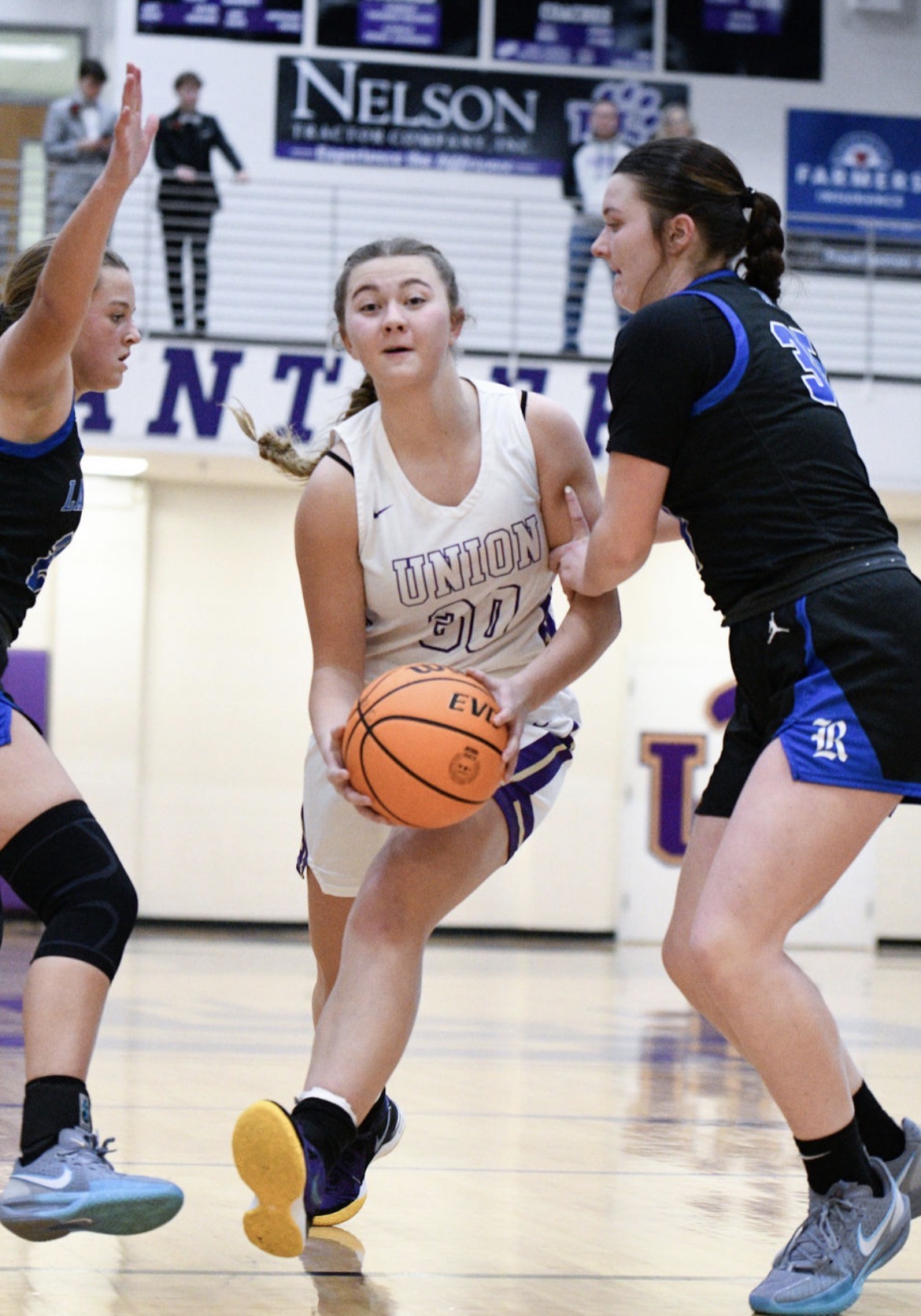 McKenna G Hood attacking the lane through two Lady Rangers defenders in the Union County home whites